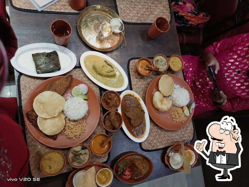 Take a seat at one of the tables at Saptapadi Restaurant.