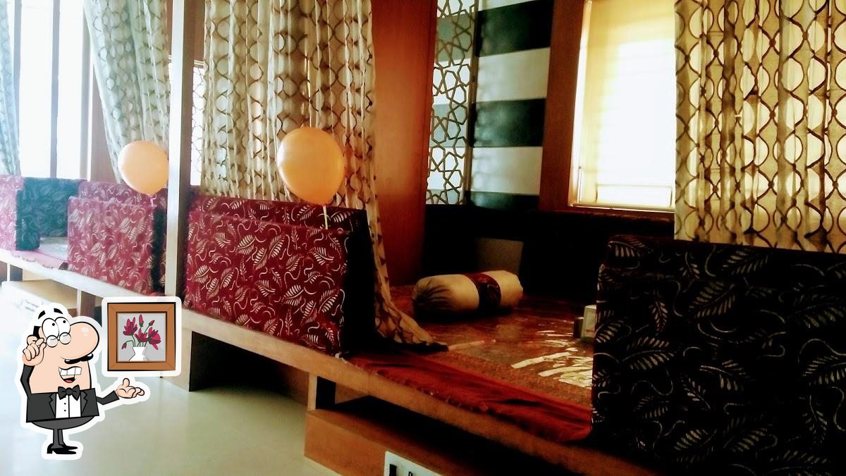 Take a seat at one of the tables at Palmshore Restaurant Ashok Nagar.