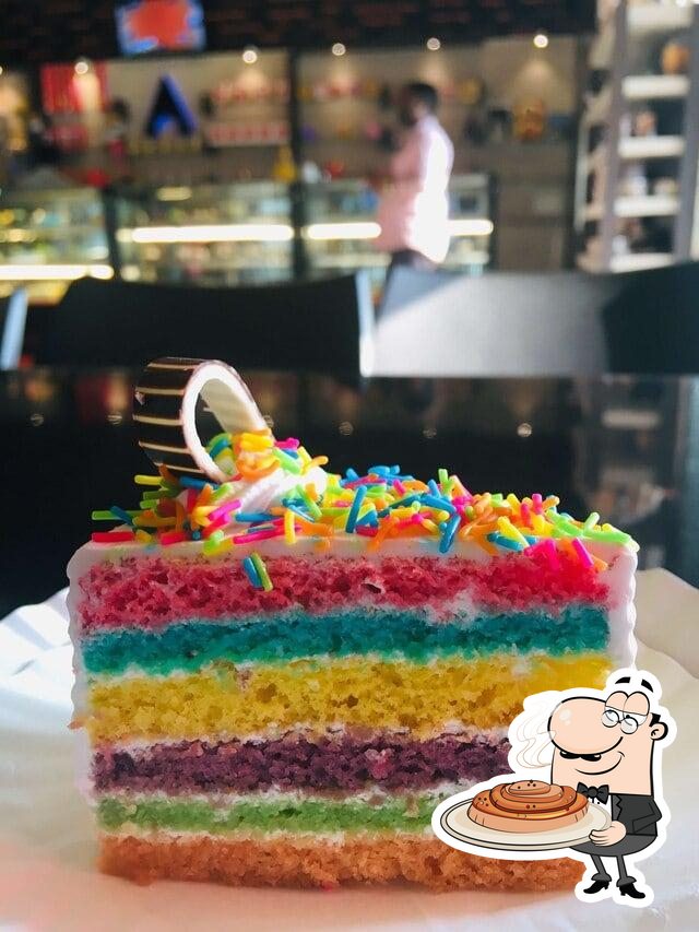 Piece of Rainbow Sponge Cake with Cream Stock Photo - Image of kids, green:  218064204