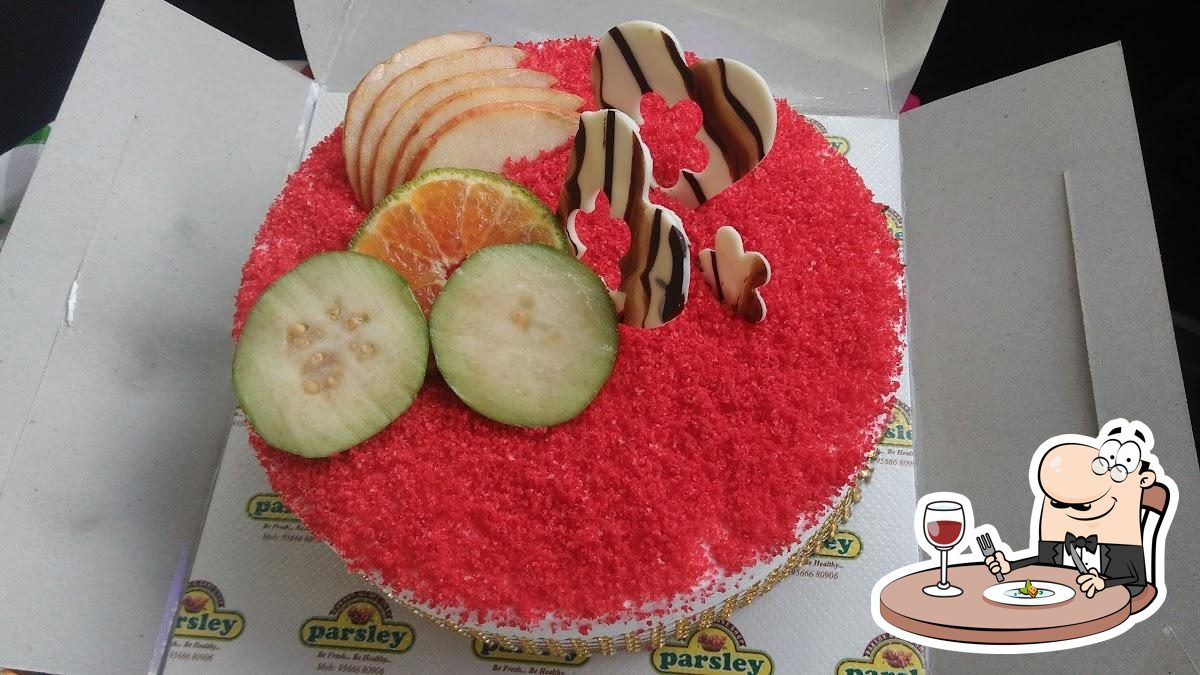 Premium Photo | Carrot cake with chocolate frosting served on a round plate  with slices of carrots and parsley on a rustic table with a saucer