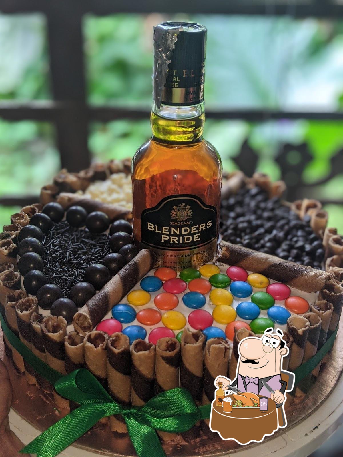 Cake with actual Blenders Pride 180ml bottle! Flavour of cake is  butterscotch caramel. Topped with macarons ferero and kitkat 😁 | Instagram