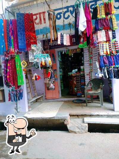 Take a seat at one of the tables at Shree Namdev Chat Center Patasi Bhandar