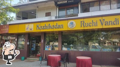 Take a seat at one of the tables at Kozhikoden Ruchi Vandi