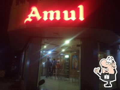 Take a seat at one of the tables at Amul Ice-Cream Corner