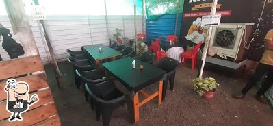 Take a seat at one of the tables at The Rasoi Pure Veg Family Restaurant