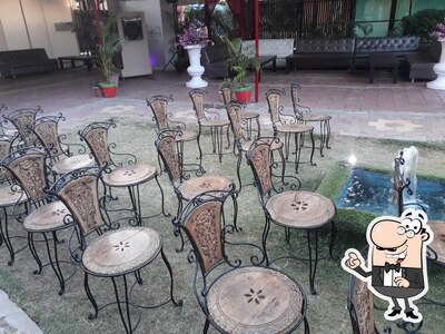 Take a seat at one of the tables at Potters Cafe And Restaurant