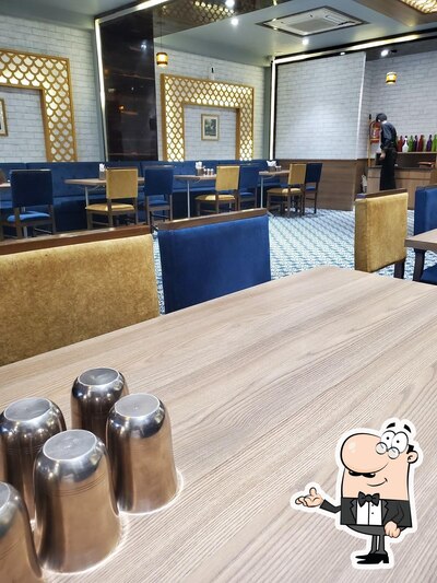 Take a seat at one of the tables at Sankalp Restaurant