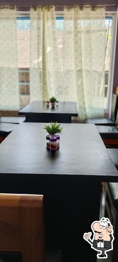 Take a seat at one of the tables at Shambhu Hotel