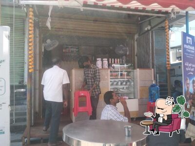 Take a seat at one of the tables at Mysore Filter Coffee House