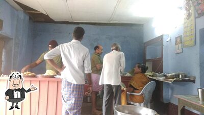 Take a seat at one of the tables at Ganesh Tiffin Center(Panthulugari Hotel)