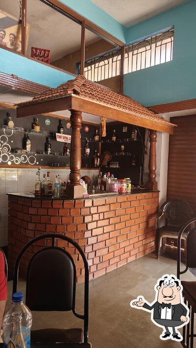 Take a seat at one of the tables at Kishore Bar N Restaurant