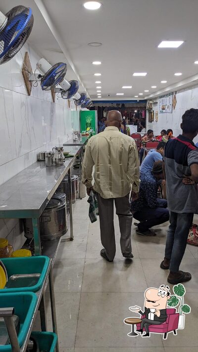 Take a seat at one of the tables at Surya Fast Food And Tiffin Centre