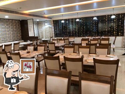 Take a seat at one of the tables at Manika Restaurants