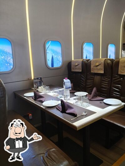 Take a seat at one of the tables at Fly Kouzina