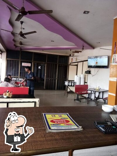Take a seat at one of the tables at HOTEL PRIYA