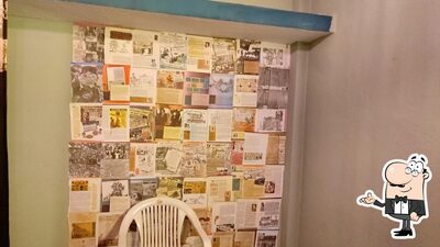 Take a seat at one of the tables at Apna Cafe