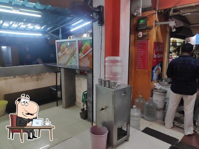 Take a seat at one of the tables at Dosa Paradise Mini Restaurant