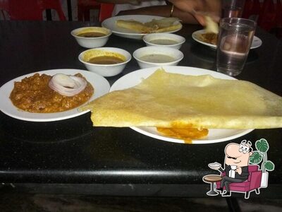 Take a seat at one of the tables at Indian Coffee House