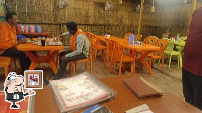 Take a seat at one of the tables at Kathiyawadi Restaurant