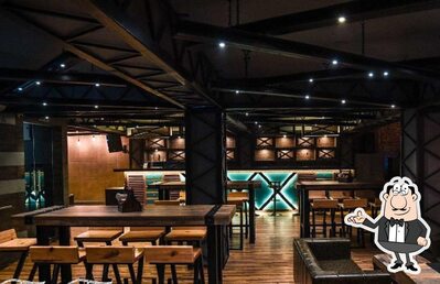 Take a seat at one of the tables at Tipsy Tales Bar Terminal