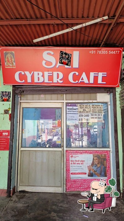 Take a seat at one of the tables at SAI CYBER CAFE