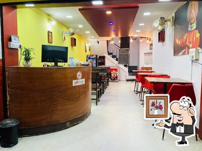 Take a seat at one of the tables at Malayali Cafe