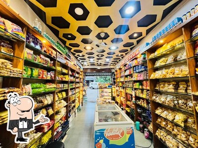 Take a seat at one of the tables at Mahalaxmi Bakery And Sweet Mart