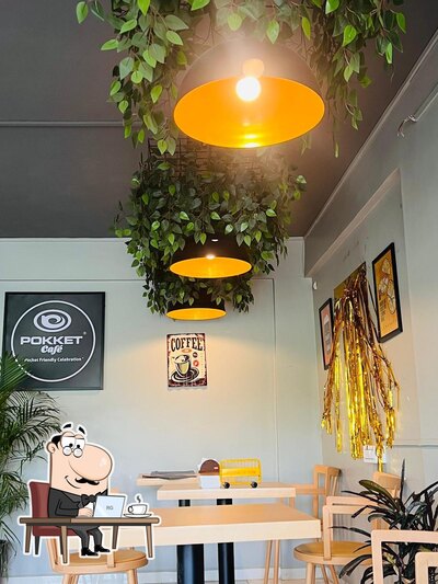 Take a seat at one of the tables at Pokket Cafe Shirur