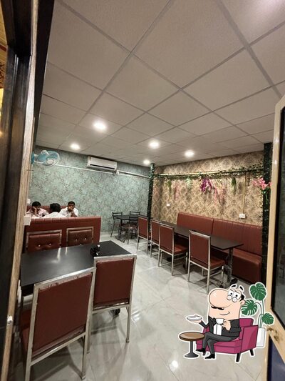 Take a seat at one of the tables at Hotel Bhupathi's Grand A/C family Restaurant