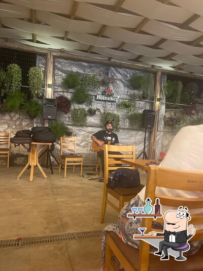 Sente em uma das mesas no Seu Bartô