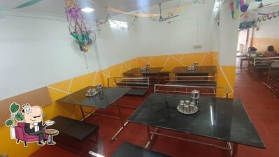 Take a seat at one of the tables at HOTEL MAHARAJA