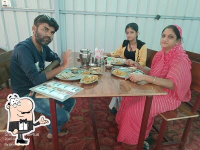 Take a seat at one of the tables at Rudra Restaurant
