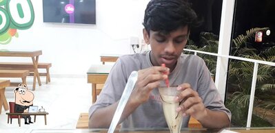 Take a seat at one of the tables at FRUTO resto cafe