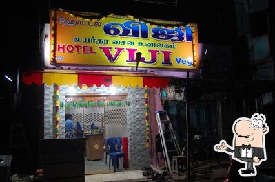 Take a seat at one of the tables at Viji Hotel