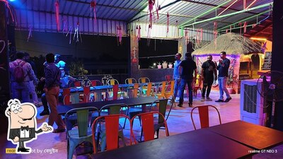 Take a seat at one of the tables at Food & Fusion Prem's Cafe & Lounge