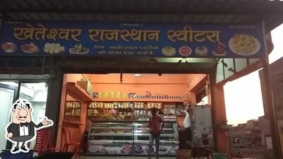 Take a seat at one of the tables at KHETESHWAR RAJSTHAN SWEETS