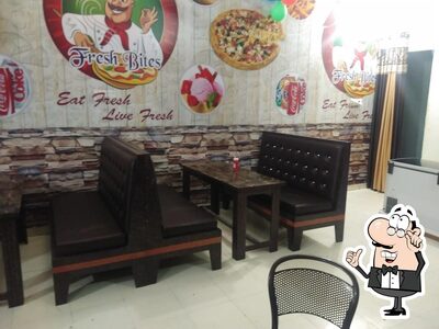 Take a seat at one of the tables at Fresh Bites Restaurant