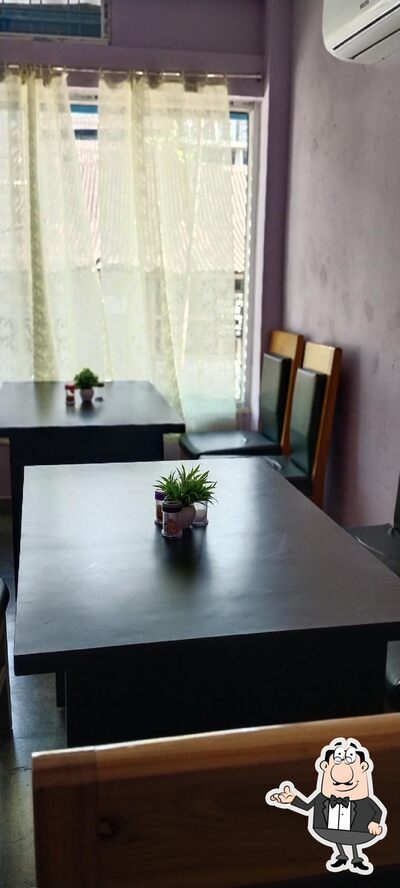 Take a seat at one of the tables at Shambhu Hotel