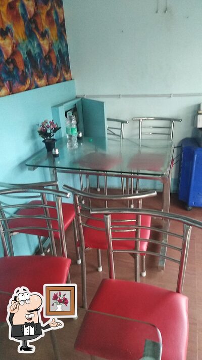 Take a seat at one of the tables at TIWARI HOTEL
