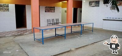 Take a seat at one of the tables at Nisarga Family Restaurant