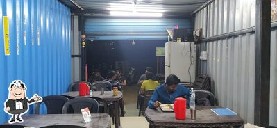 Take a seat at one of the tables at Maharashtratil Famous Dahi Dhapate