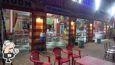 Take a seat at one of the tables at Aasha Restaurant