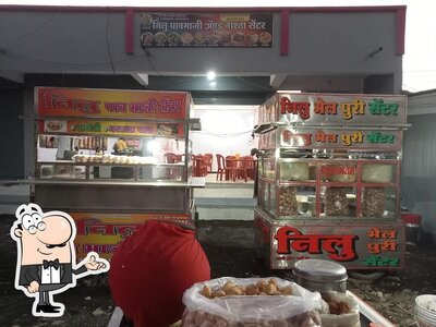 Take a seat at one of the tables at Nilu Bhelpuri Center