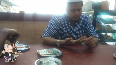 Take a seat at one of the tables at Amar Bakery,Cafe&Sweets