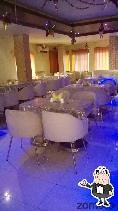 Take a seat at one of the tables at Mayur Restaurant