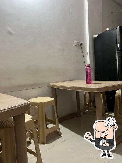 Take a seat at one of the tables at Madras IDLI - DOSA POINT