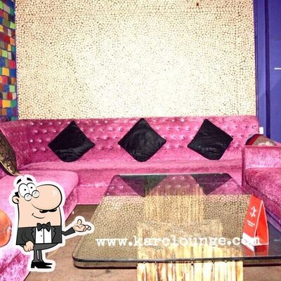 Take a seat at one of the tables at Kar C Lounge & Restaurant