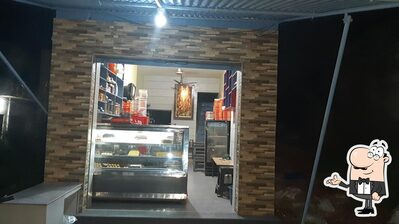 Take a seat at one of the tables at Sharma Sweets & Snacks
