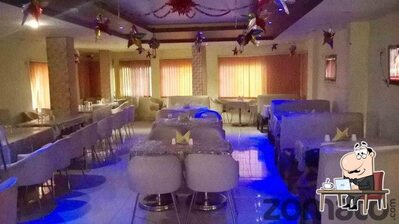 Take a seat at one of the tables at Mayur Restaurant