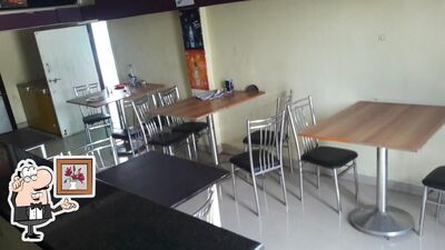 Take a seat at one of the tables at Rass Raj Restraunt & Bar